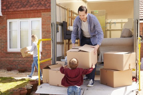 Professional packers wrapping furniture for a Paddington removal